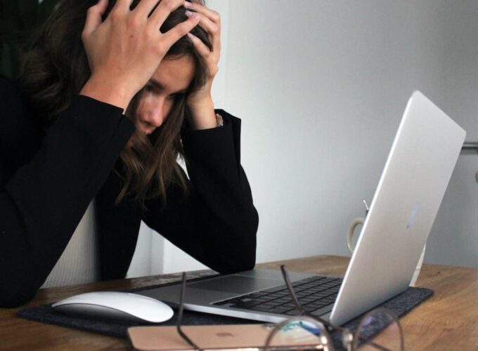 Une employée derrière son portable submergée par le stress.